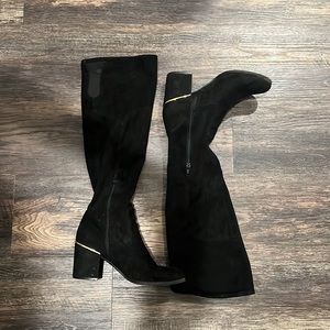 Knee high black boots with gold trim